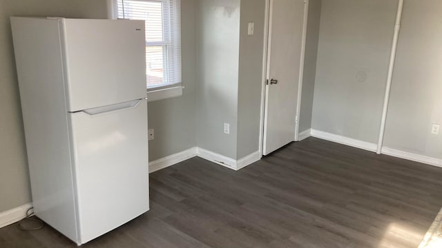 interior space with dark wood-type flooring and white refrigerator