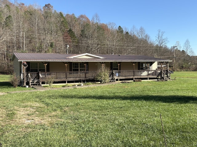 580 Bales Creek Rd, Manchester, KY 40962 - back of property featuring covered porch, a lawn, a wooded view, and metal roof