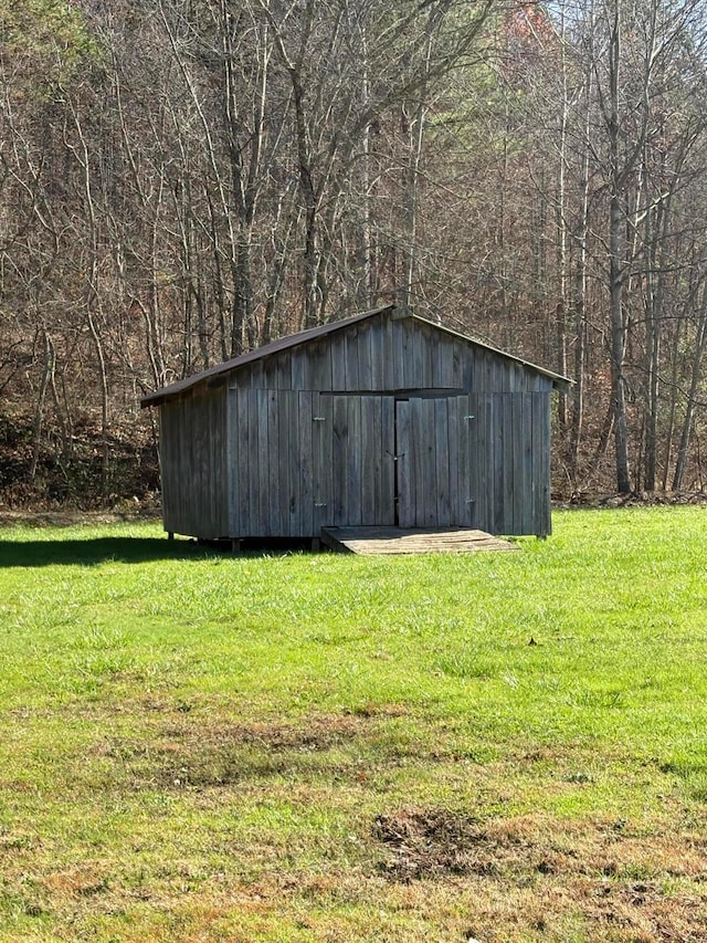 view of outbuilding with a lawn