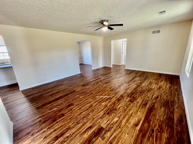 spare room with wood-type flooring, ceiling fan, and a textured ceiling