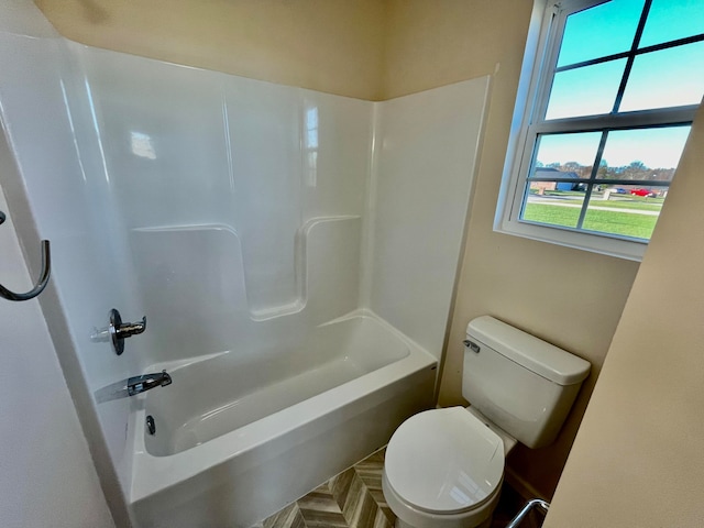 bathroom with toilet and  shower combination