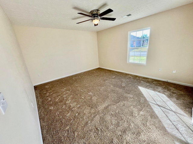 unfurnished room featuring a textured ceiling, carpet, and ceiling fan