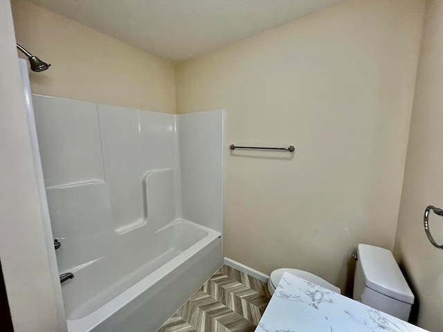 bathroom with toilet and parquet flooring