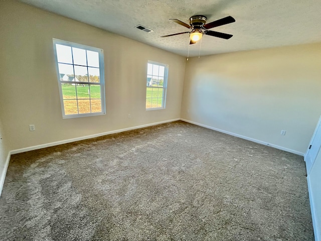 empty room with carpet flooring, a textured ceiling, and ceiling fan