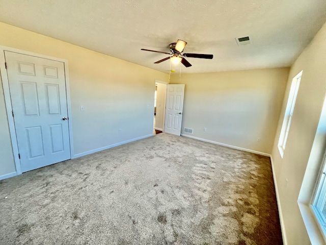 carpeted spare room with ceiling fan