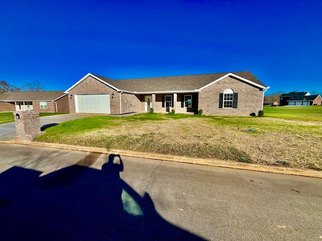 ranch-style house with a garage and a front lawn