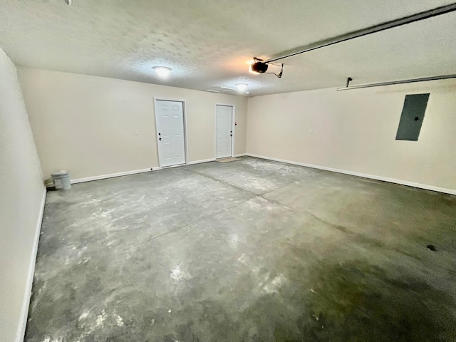 garage featuring electric panel and a garage door opener