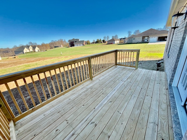 wooden deck featuring a lawn