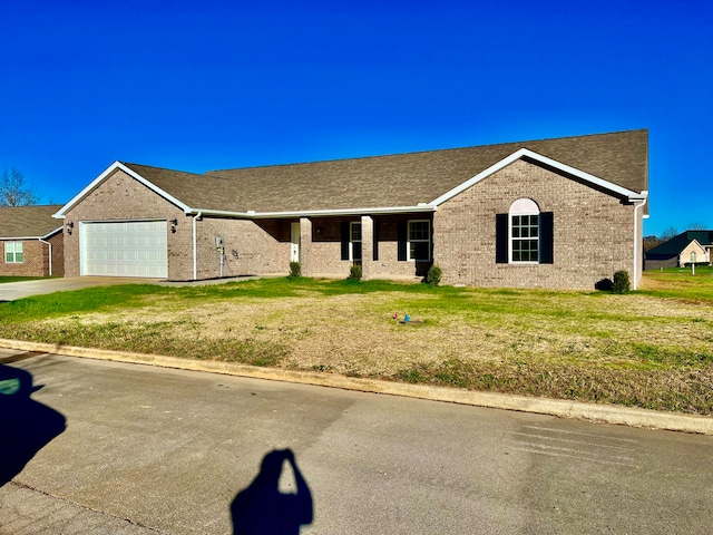 ranch-style house with a garage and a front yard