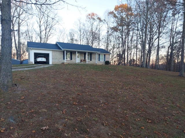 ranch-style home featuring a garage and covered porch