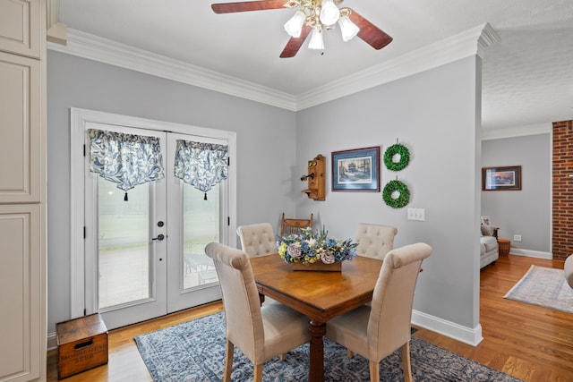 dining space featuring light hardwood / wood-style floors, french doors, and ornamental molding