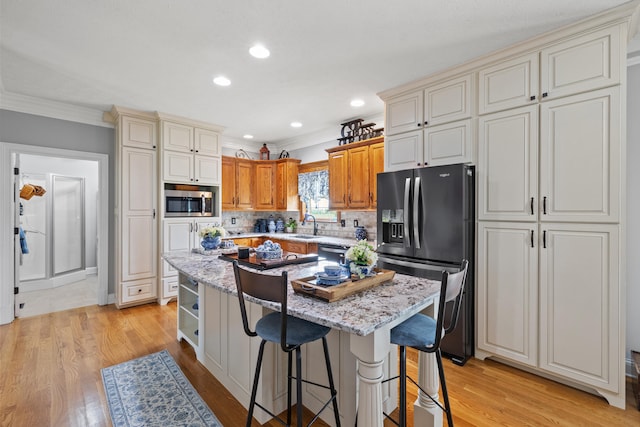 kitchen featuring light wood-type flooring, a center island, and stainless steel appliances