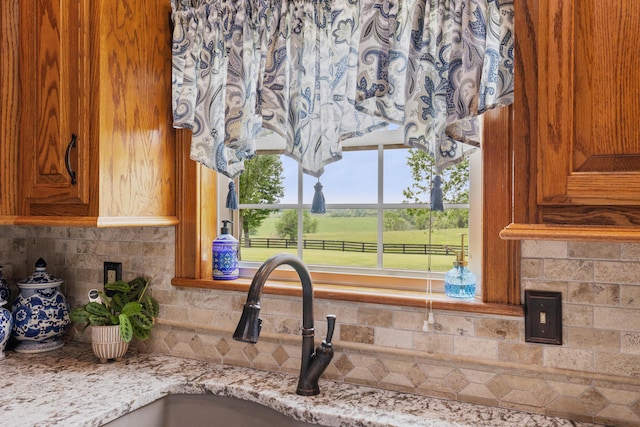 kitchen with backsplash and light stone countertops