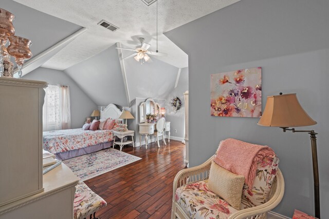 bedroom with dark wood-type flooring, ceiling fan, a textured ceiling, and lofted ceiling