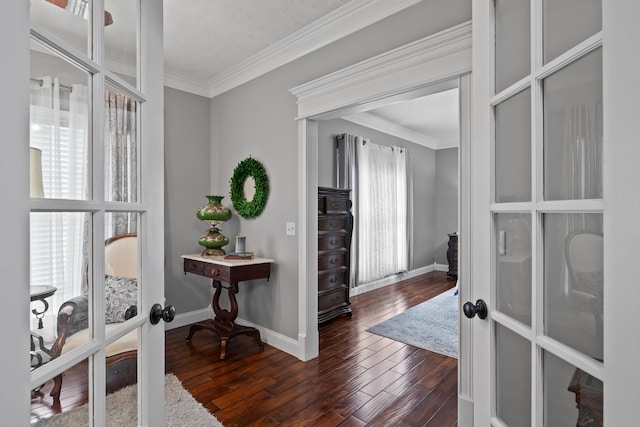 interior space featuring dark wood-type flooring, french doors, ornamental molding, and a textured ceiling