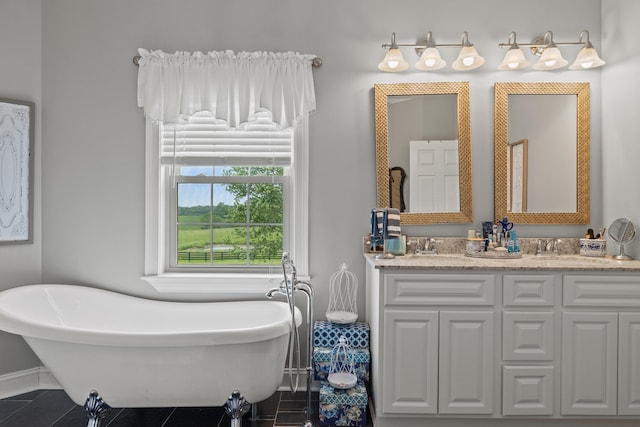 bathroom with a tub to relax in, vanity, and tile patterned flooring