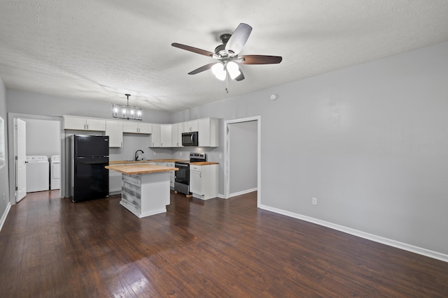 kitchen with black appliances, washer and clothes dryer, wood counters, white cabinets, and a center island