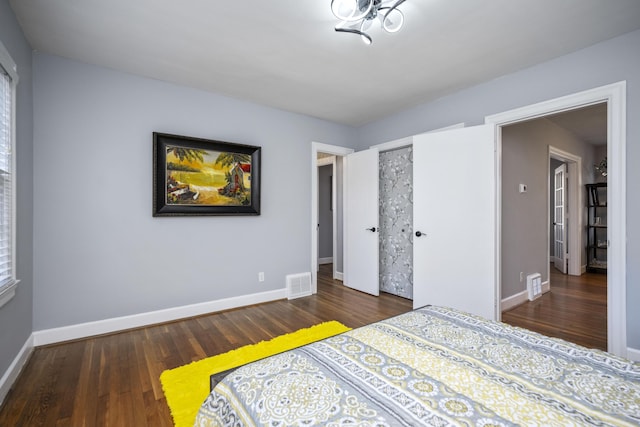 bedroom with dark hardwood / wood-style floors