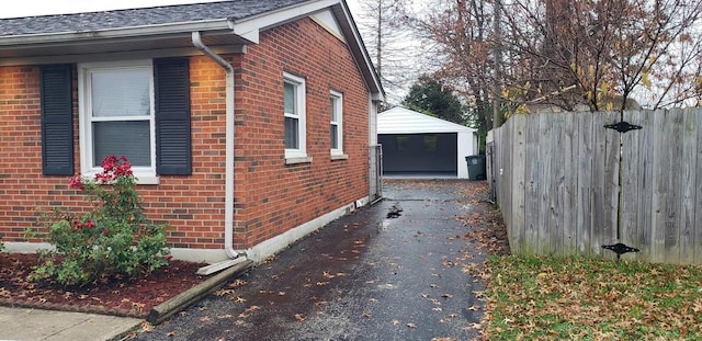 view of side of property featuring an outbuilding and a garage