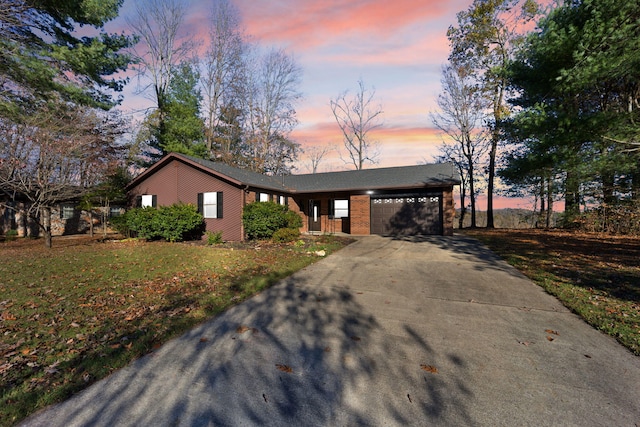 ranch-style home with a lawn and a garage