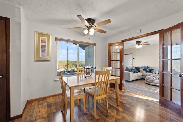 dining area featuring ceiling fan, wood-type flooring, and a textured ceiling