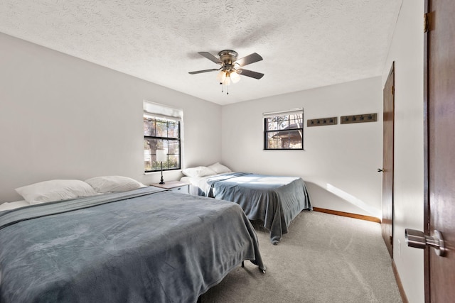 carpeted bedroom featuring a textured ceiling and ceiling fan