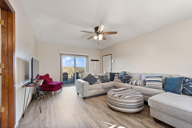 living room featuring ceiling fan and light hardwood / wood-style floors