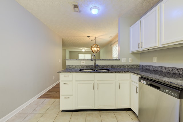 kitchen featuring kitchen peninsula, stainless steel dishwasher, dark stone counters, a textured ceiling, and sink