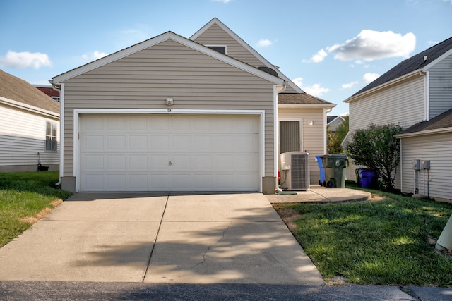 view of front of house with a garage and central AC