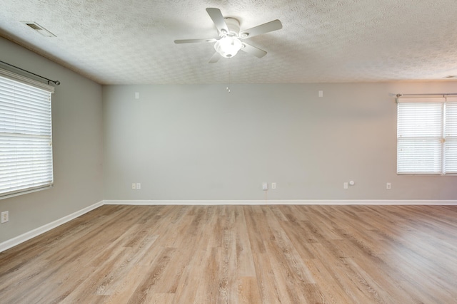 unfurnished room with plenty of natural light and light hardwood / wood-style floors