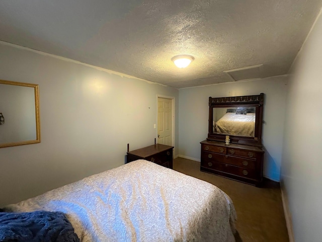 bedroom with dark carpet and a textured ceiling