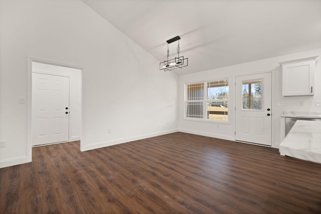 unfurnished dining area with dark hardwood / wood-style floors and high vaulted ceiling