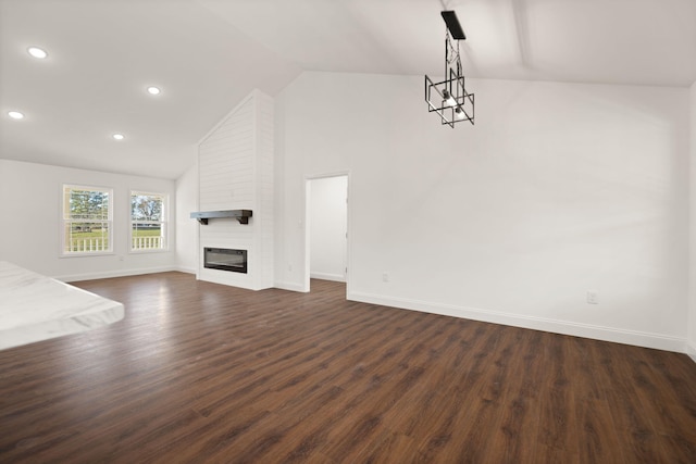 unfurnished living room featuring a fireplace, dark hardwood / wood-style floors, and vaulted ceiling