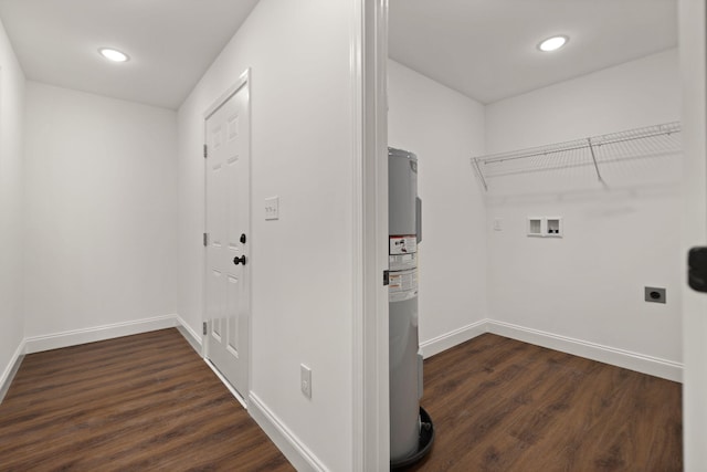 clothes washing area with washer hookup, electric water heater, dark hardwood / wood-style floors, and electric dryer hookup