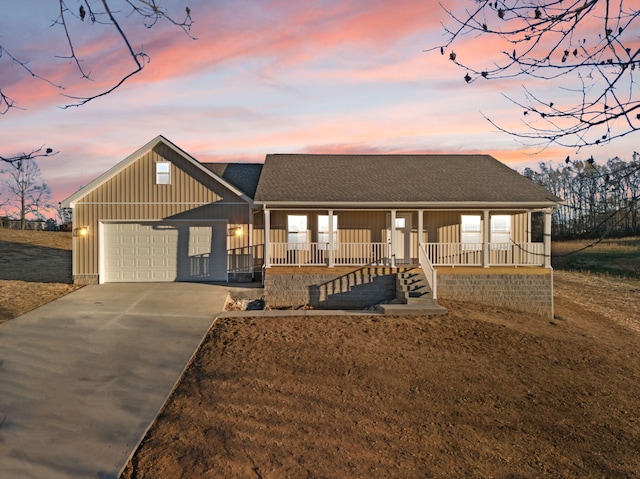 view of front of home featuring a porch and a garage