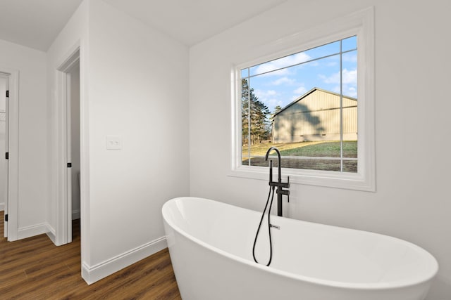 bathroom featuring a bath and wood-type flooring