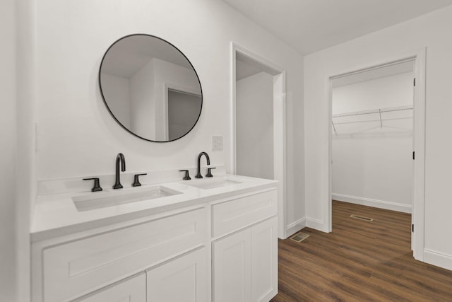 bathroom with vanity and hardwood / wood-style flooring