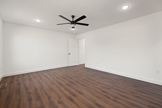 empty room featuring ceiling fan and dark wood-type flooring