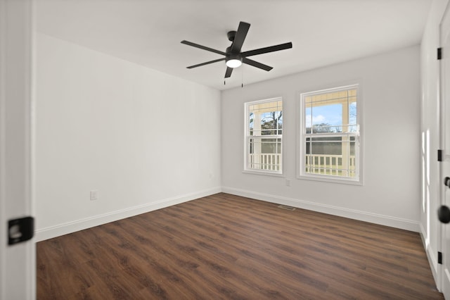 empty room with dark hardwood / wood-style floors and ceiling fan