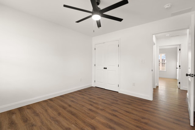 unfurnished bedroom featuring ceiling fan and dark wood-type flooring