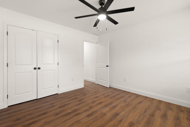 unfurnished bedroom featuring ceiling fan, dark wood-type flooring, and a closet