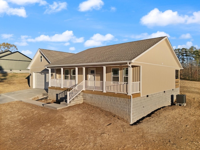 single story home with central AC unit, a garage, and covered porch