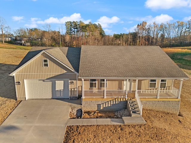 view of front of home featuring covered porch and a garage