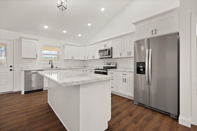 kitchen featuring a center island, dark wood-type flooring, white cabinets, vaulted ceiling, and appliances with stainless steel finishes