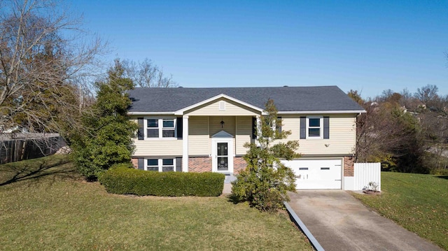 split foyer home with a garage and a front lawn