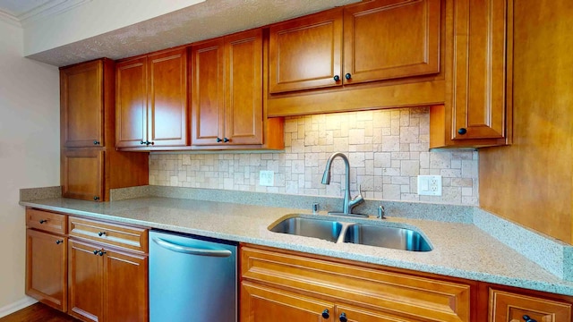 kitchen with sink, ornamental molding, dishwasher, light stone countertops, and backsplash