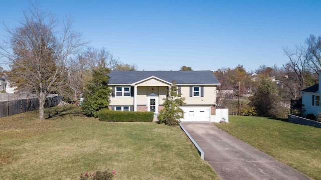 raised ranch with a garage and a front yard