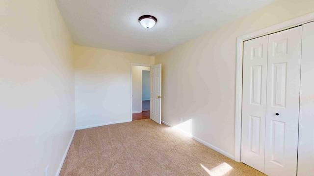 empty room featuring light colored carpet