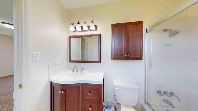 full bathroom with toilet, vanity, bath / shower combo with glass door, and backsplash