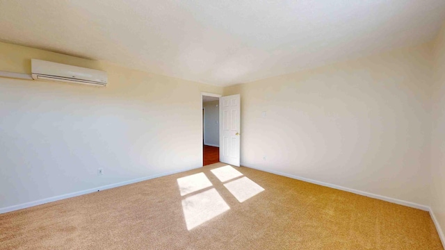 carpeted empty room with a wall unit AC